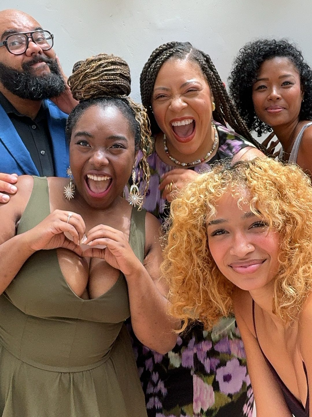 Guests laughing together and making a heart with their hands
